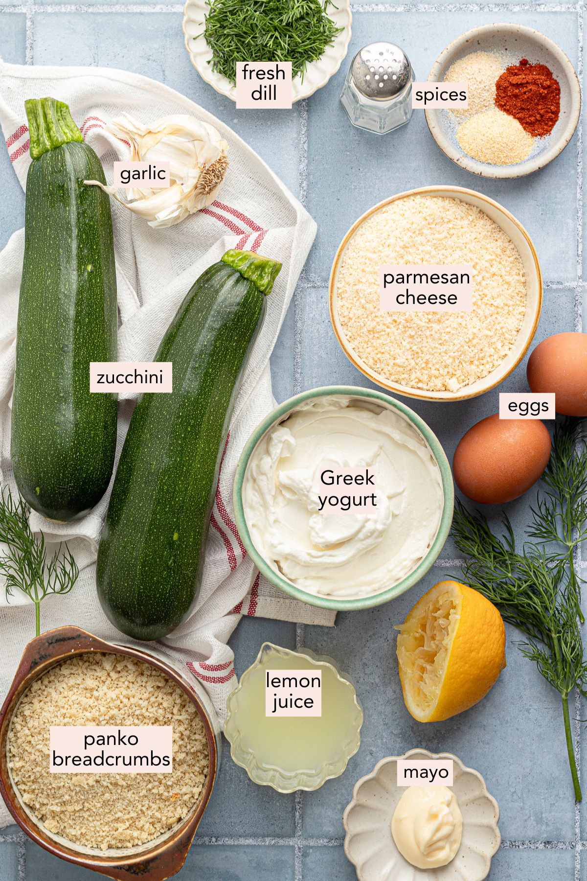 Ingredients for air fryer zucchini fries on a countertop with labels.