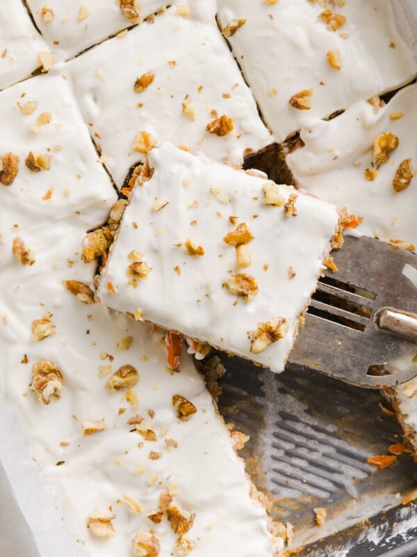 Carrot cake baked oats in a pan with slices.