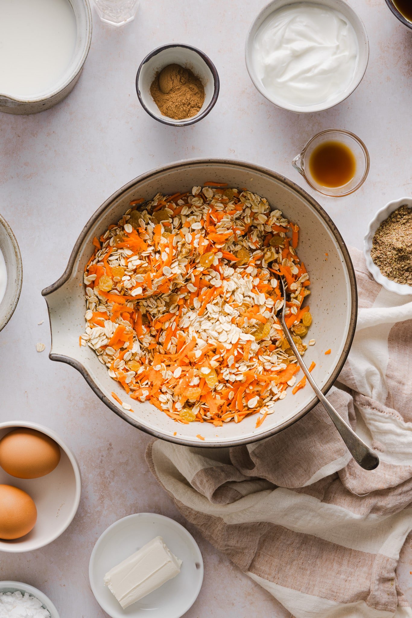 Carrot cake baked oat ingredients being mixed in a mixing bowl.