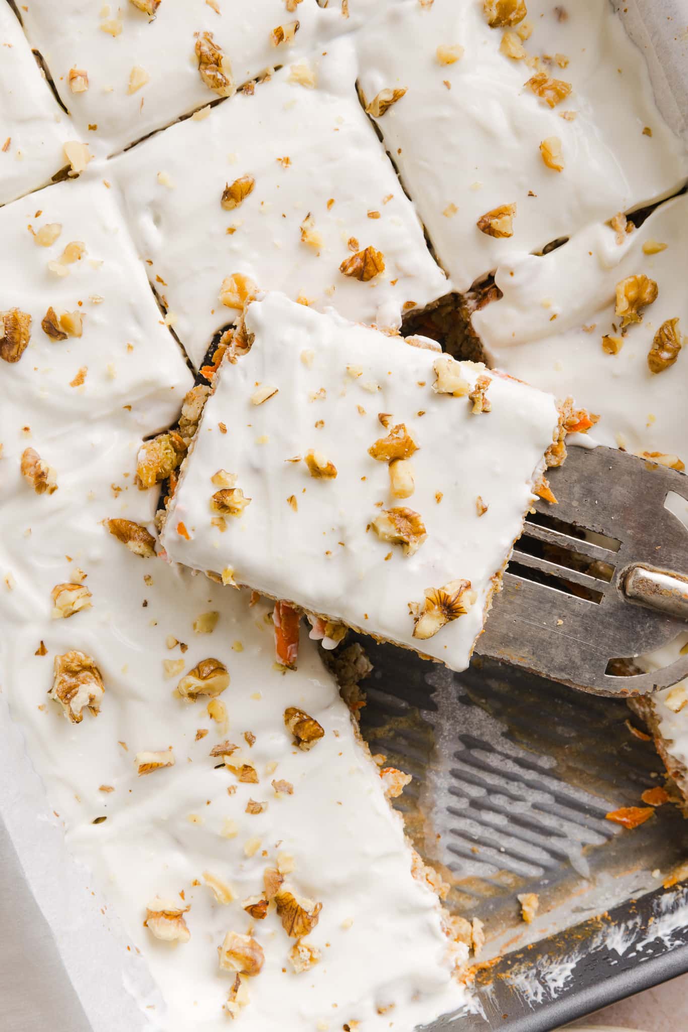 Carrot cake baked oats in a pan with slices.