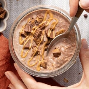 Chocolate peanut butter overnight oats in a jar with a spoon.
