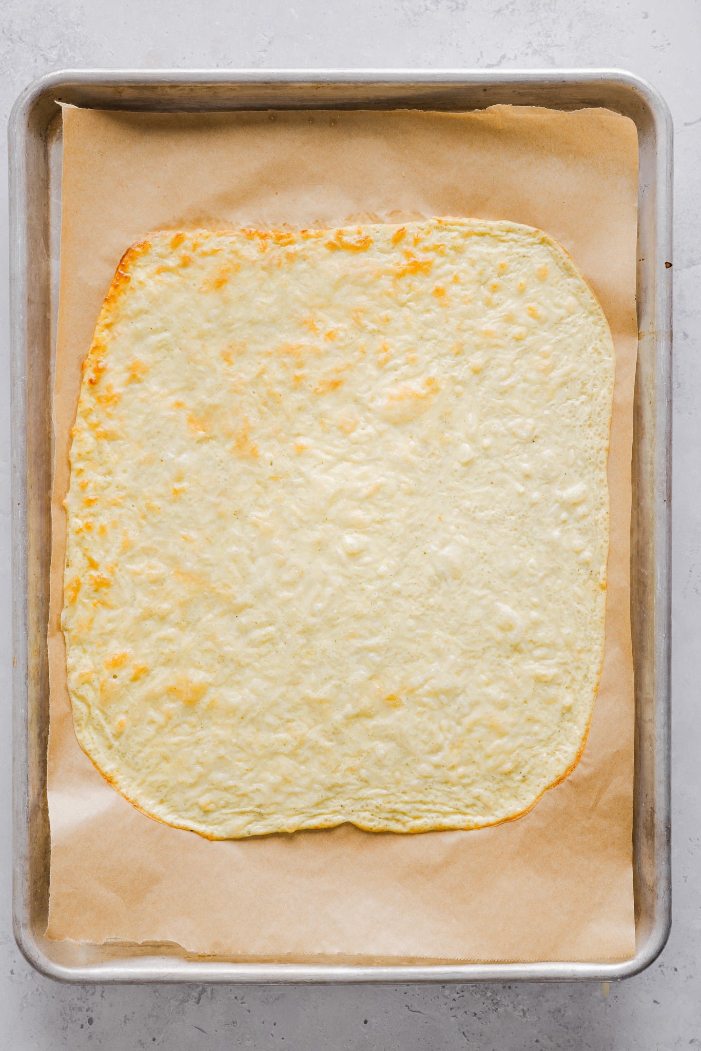 A cottage cheese egg wrap on a sheet pan.