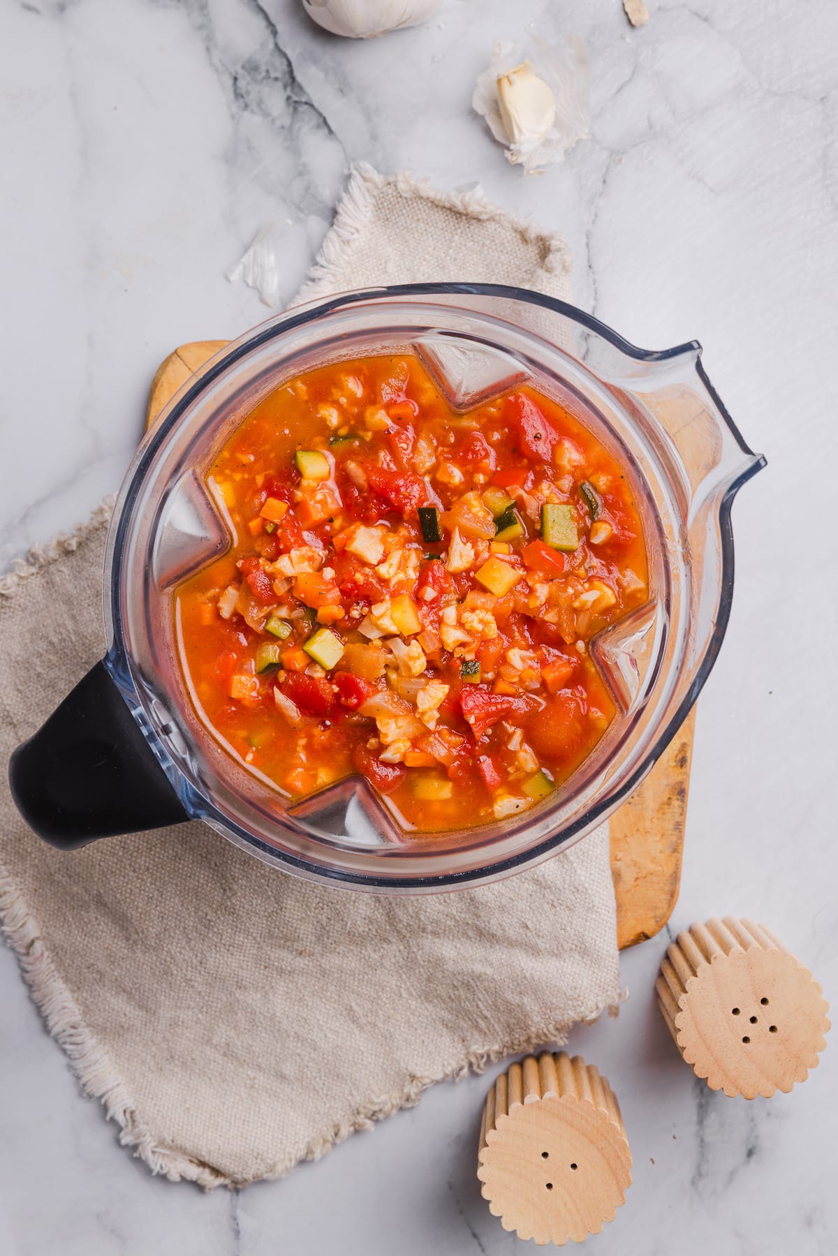 Sautéed veggies added to a blender for hidden veggie tomato sauce.