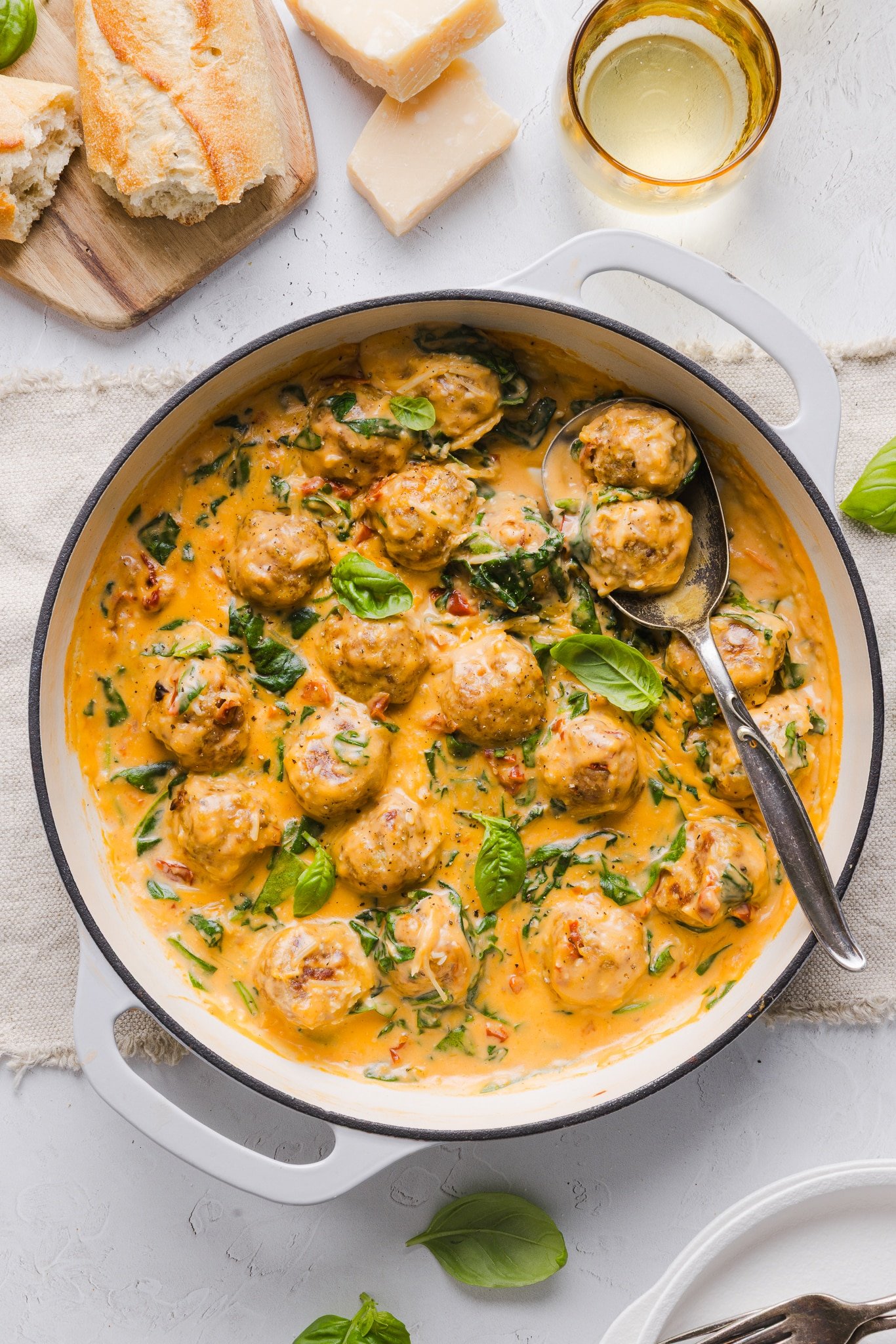 Marry me chicken meatballs in a pan garnished with fresh basil.