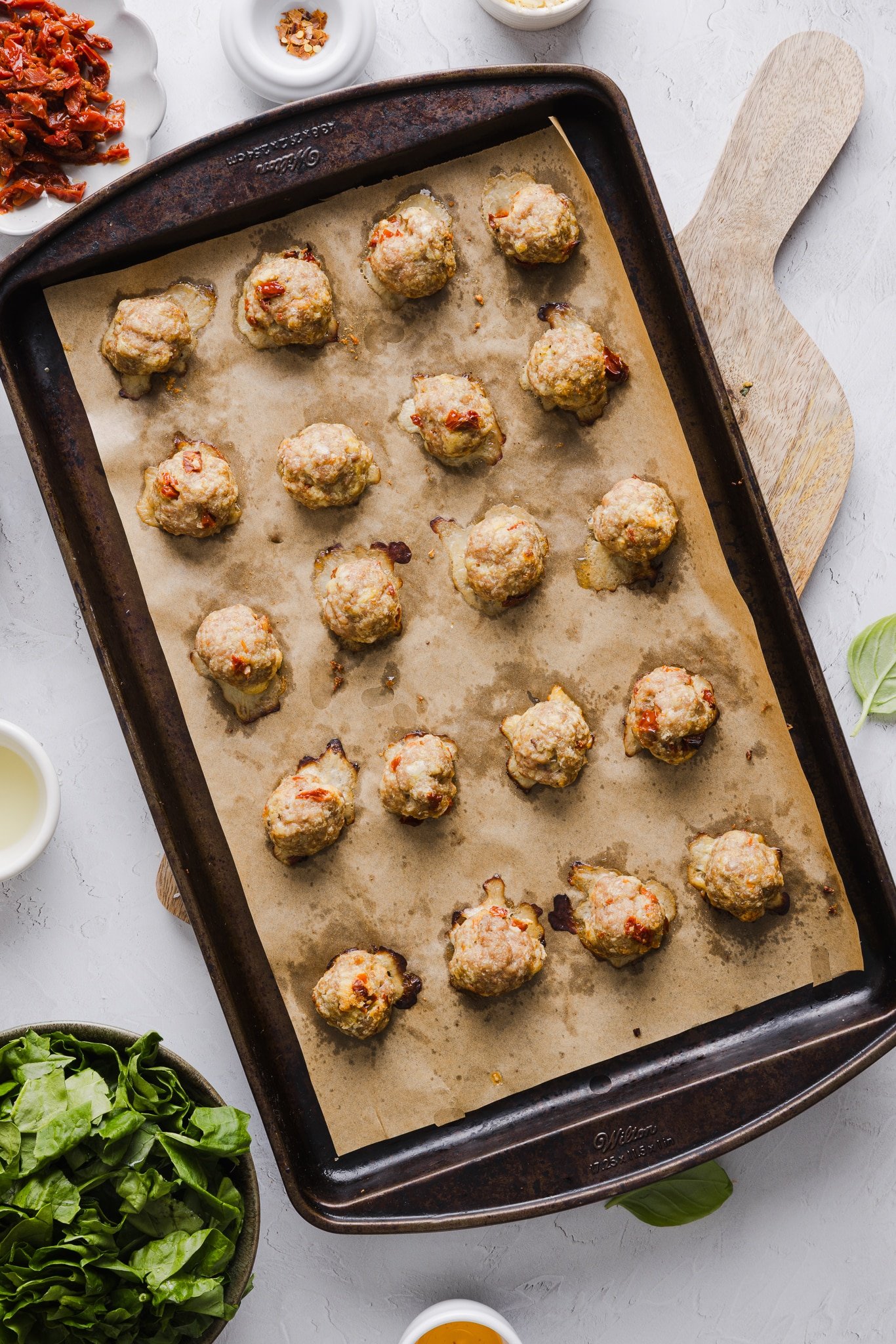 Marry me chicken meatballs baked on a sheet pan.