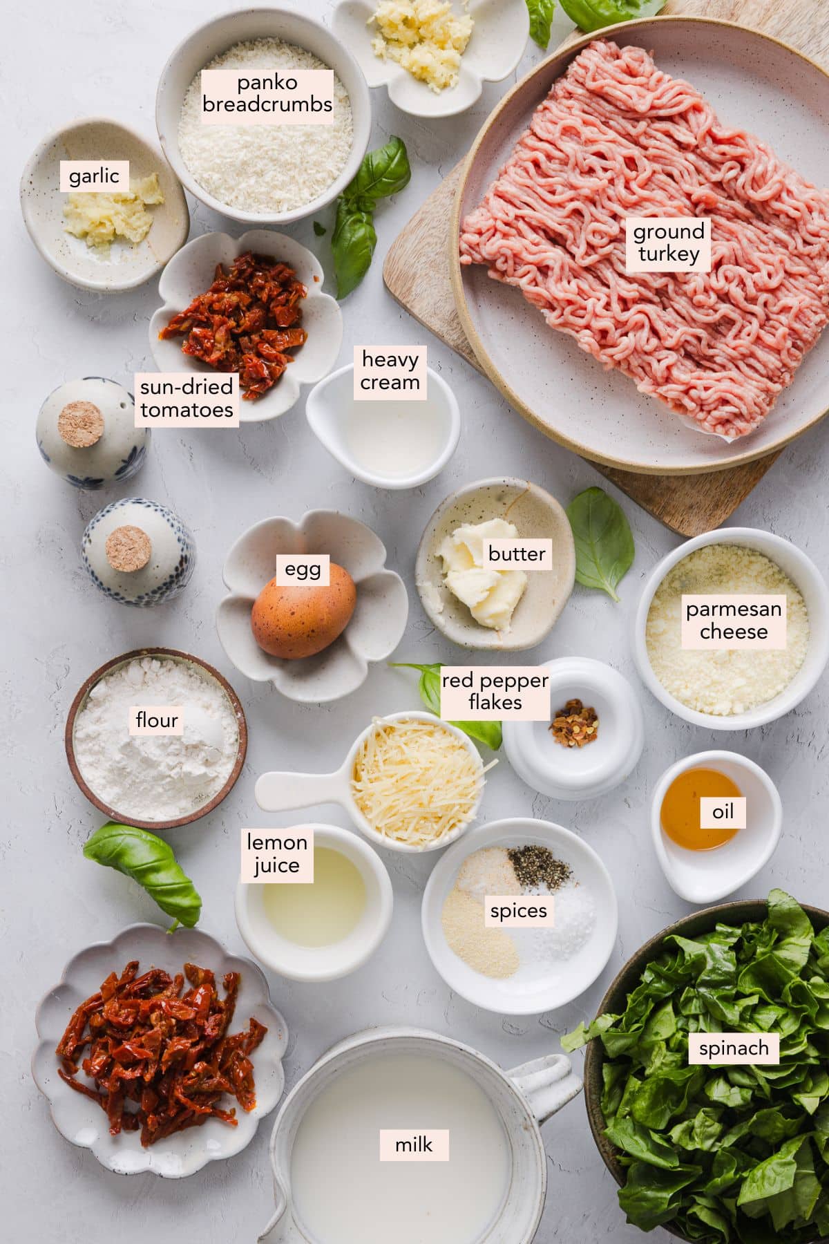 Ingredients for marry me chicken meatballs on a countertop with labels.