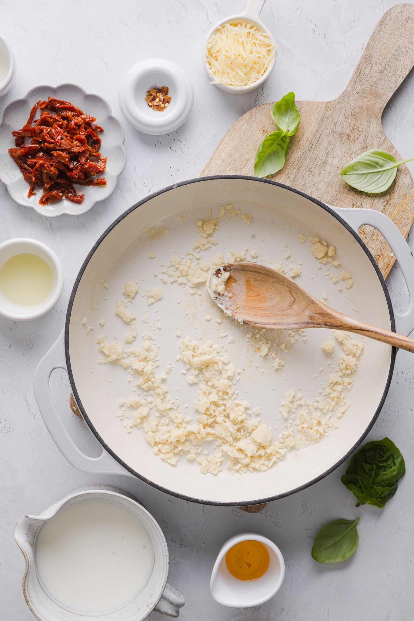Butter garlic and flour making a roux in a pan.