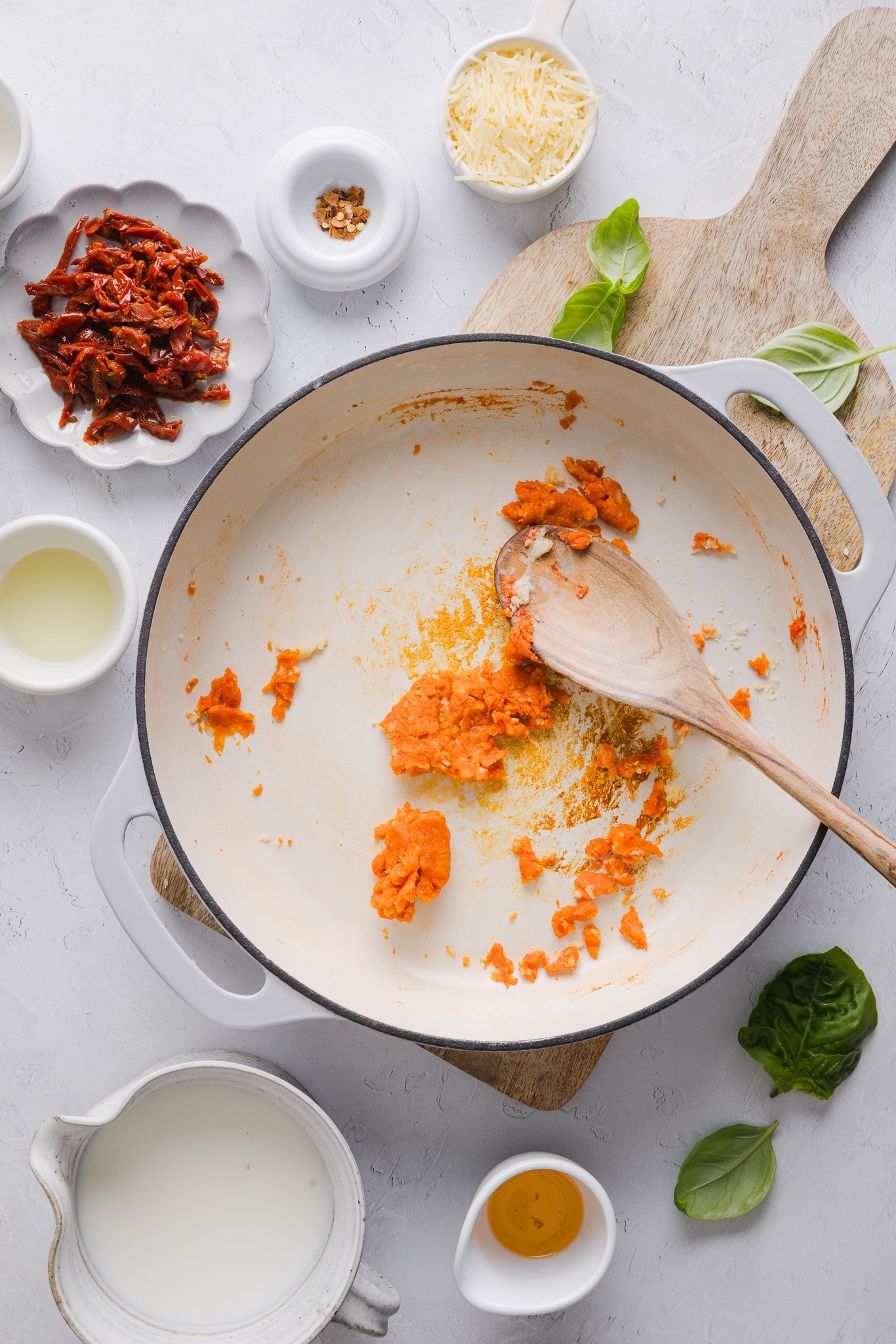 Tomato paste being added to a roux.