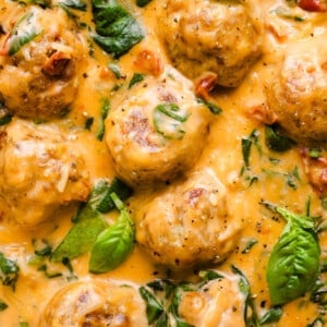A close up shot of marry me chicken meatballs in a creamy sauce.