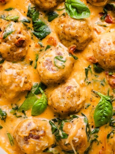 A close up shot of marry me chicken meatballs in a creamy sauce.