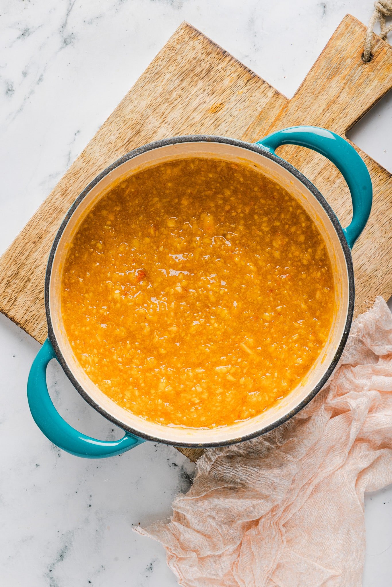 Peach freezer jam mixture in a large pot.