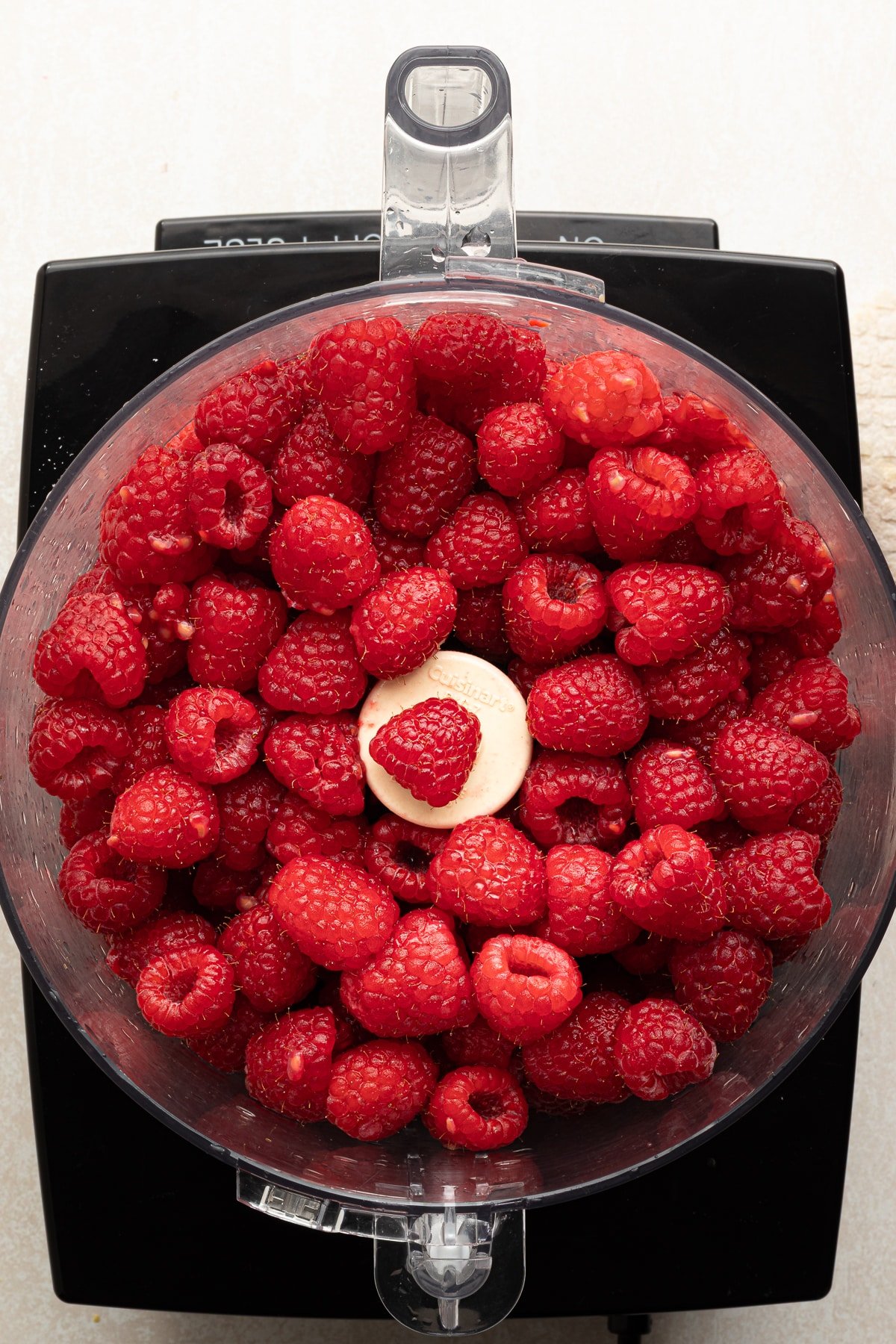 Raspberries in a food processor.
