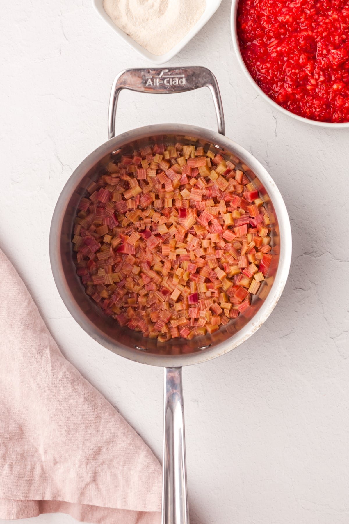 Diced rhubarb cooking in a sauce pan.