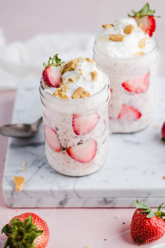 Strawberry cheesecake overnight oats topped with graham crackers and strawberries.