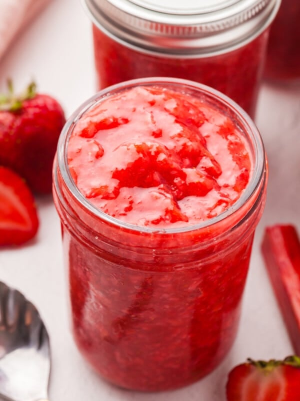 Low sugar strawberry rhubarb freezer jam in a mason jar.