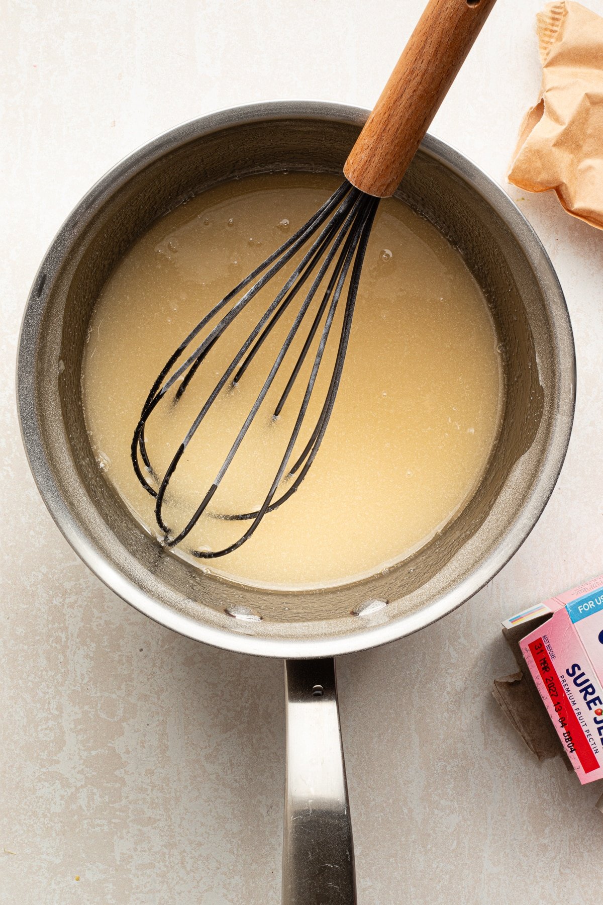 Sugar, pectin and water mixed in a pan. 