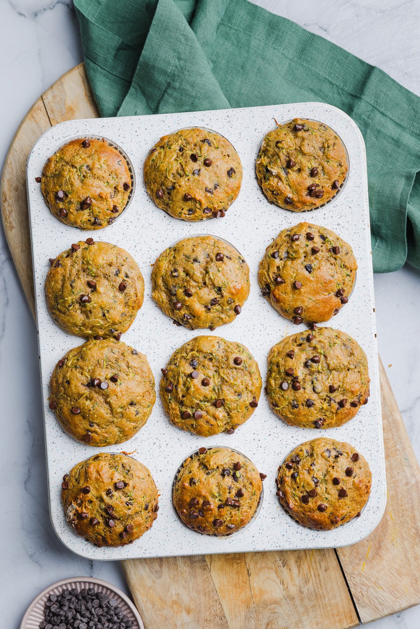 Baked zucchini protein muffins in a pan.
