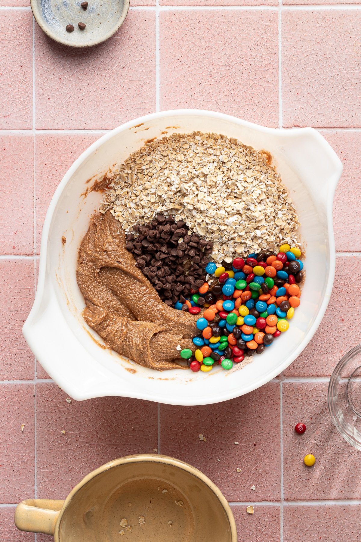 Ingredients for monster protein balls in a white bowl about to be mixed.