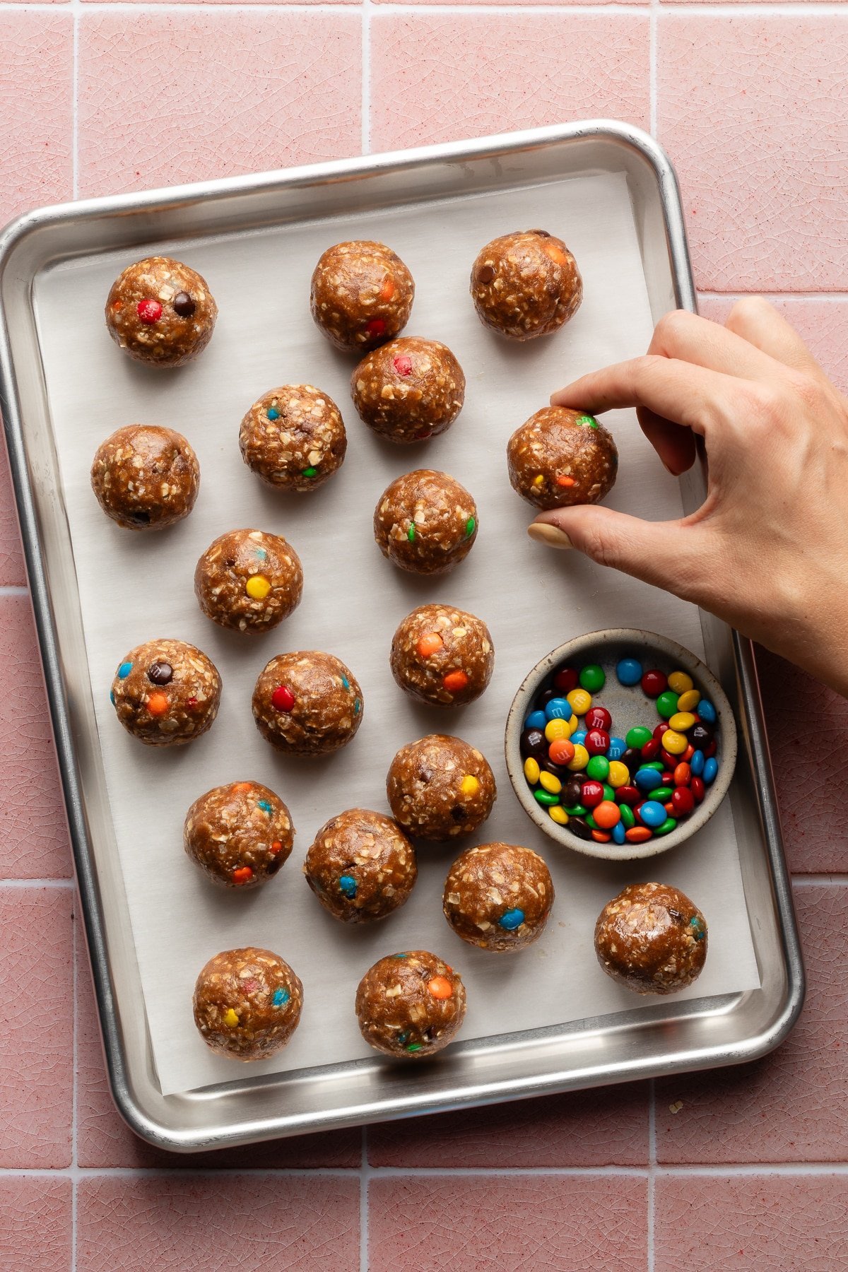 Monster protein balls on a lined baking sheet.
