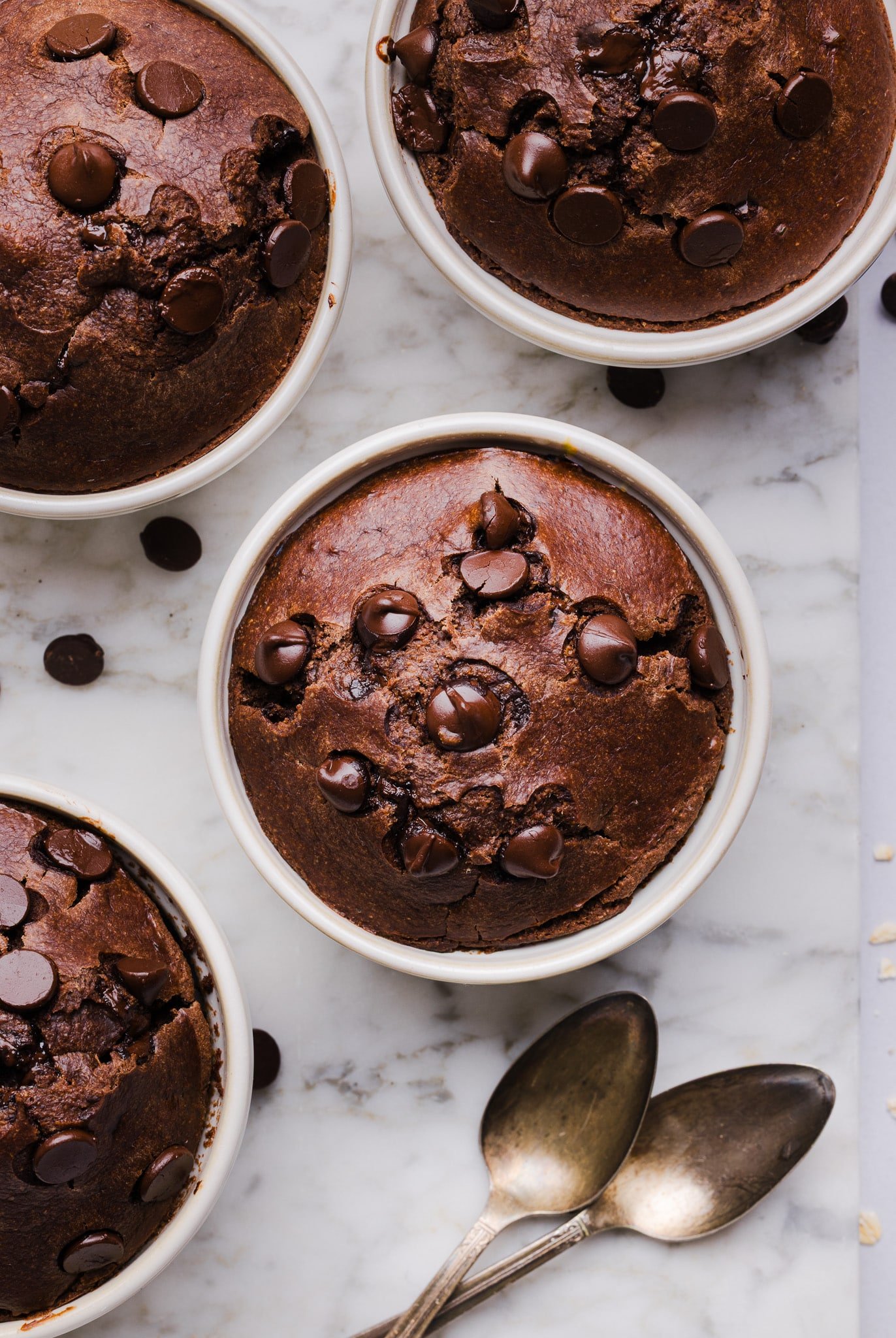 Chocolate baked oats in white ramekins.
