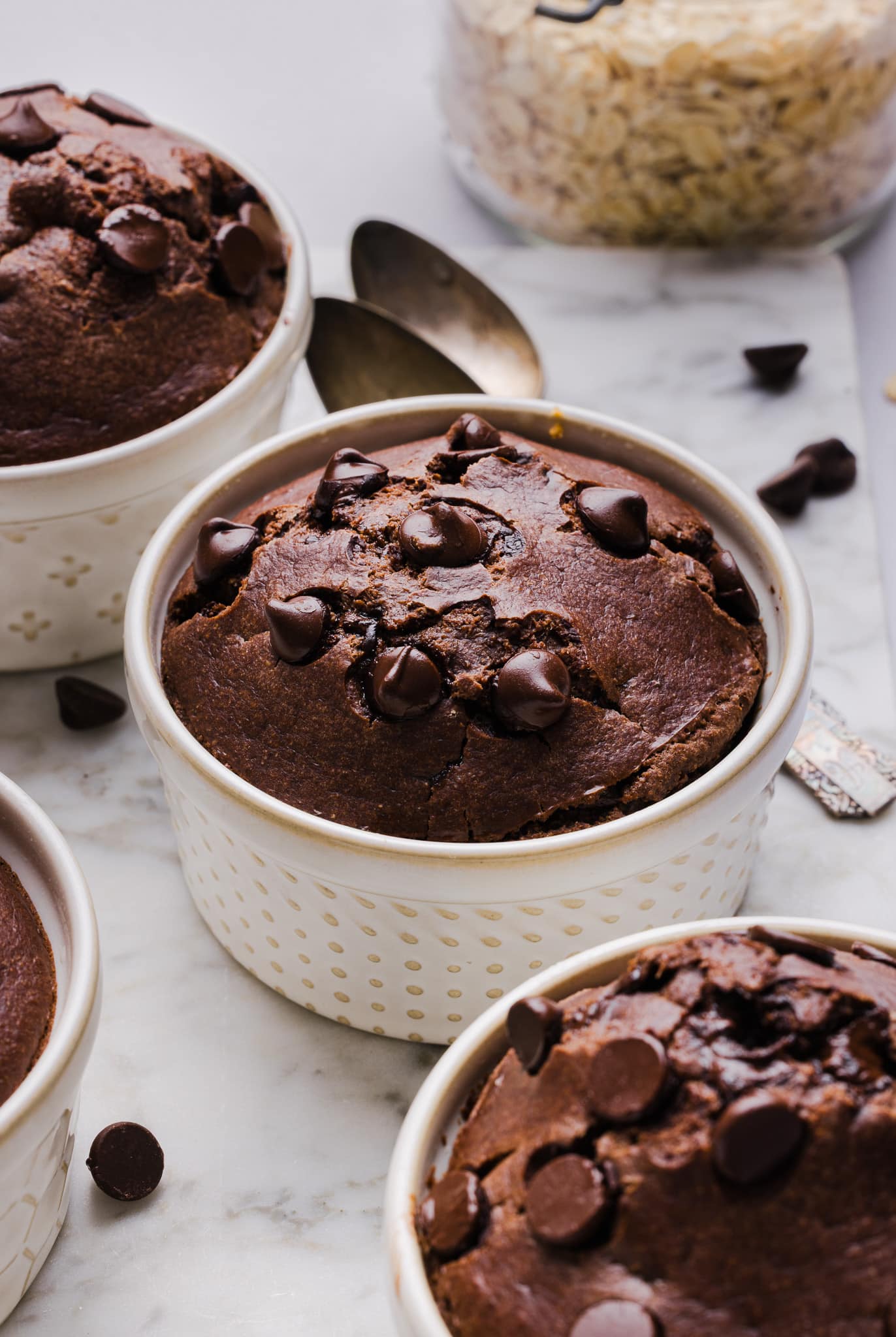 Chocolate baked oats in white ramekins.