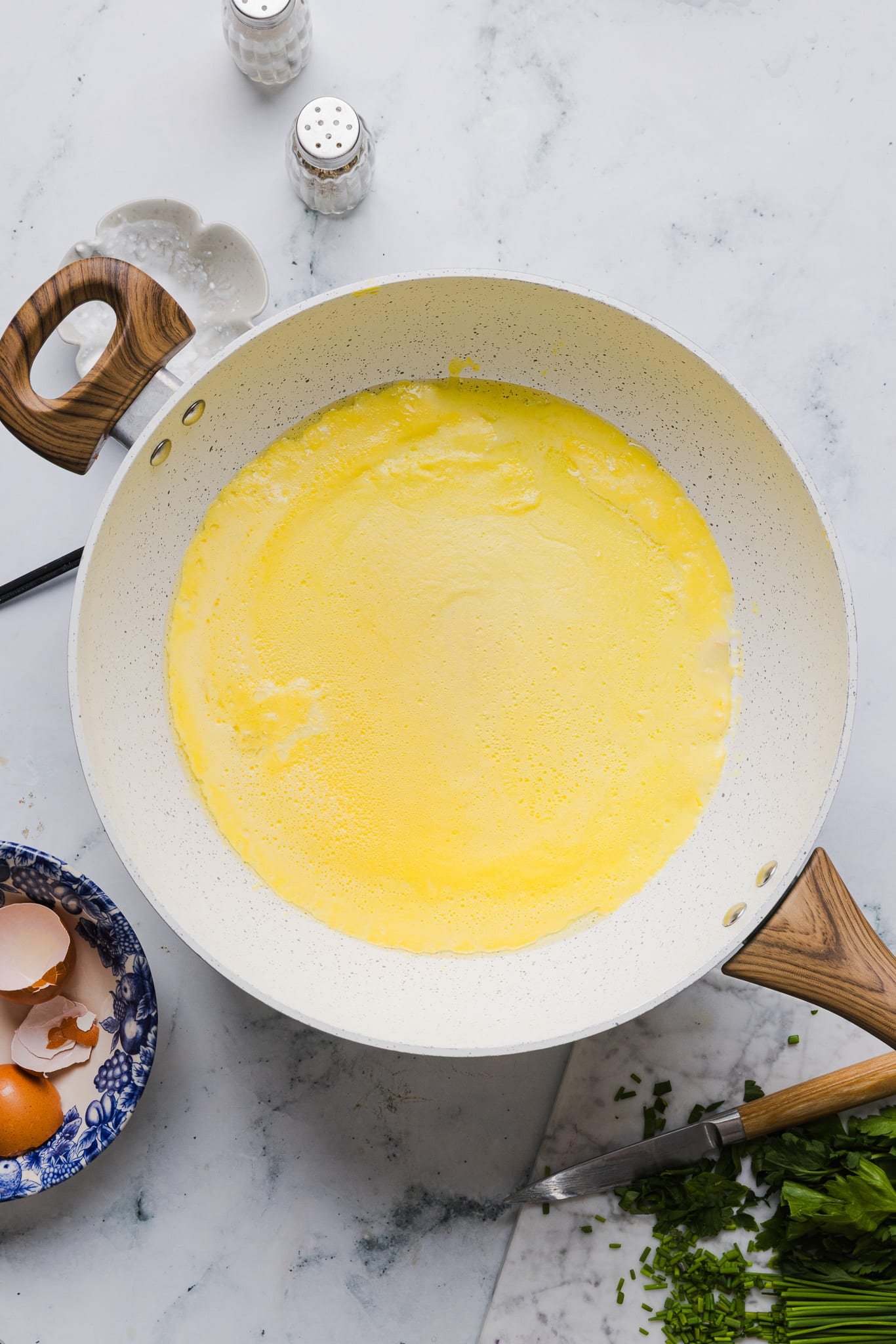 Blended eggs, cottage cheese, and salt cooking in a skillet.