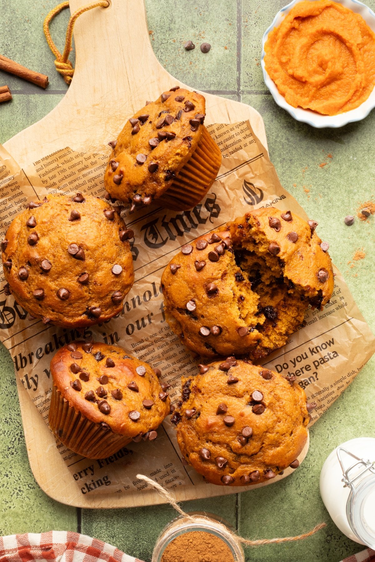 Cottage cheese pumpkin muffins on a wooden cutting board.