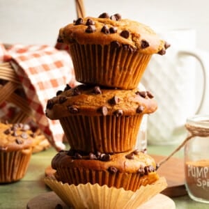 Cottage cheese pumpkin muffins stacked on top of one another.