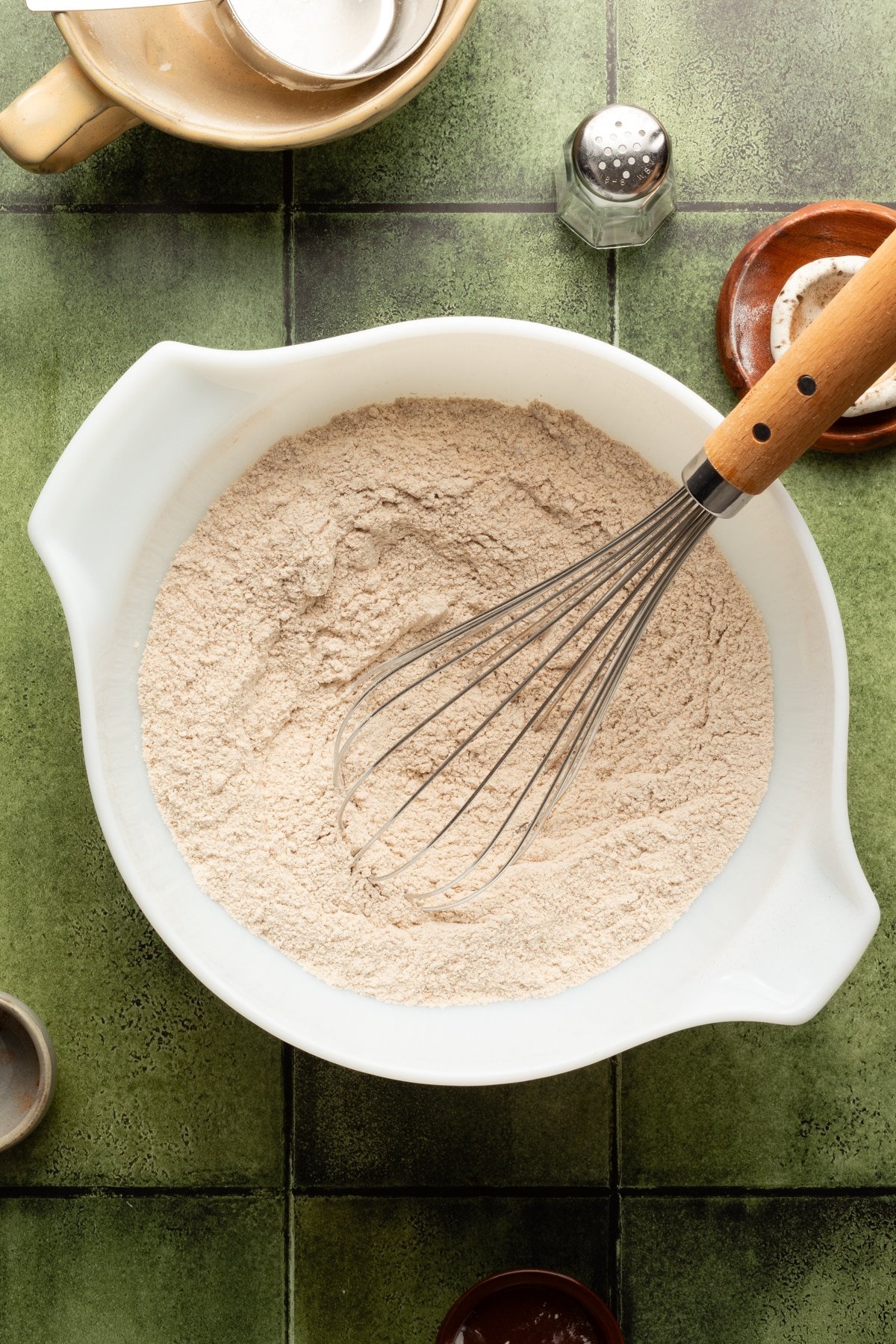Dry ingredients for cottage cheese pumpkin muffins being whisked in a bowl. 