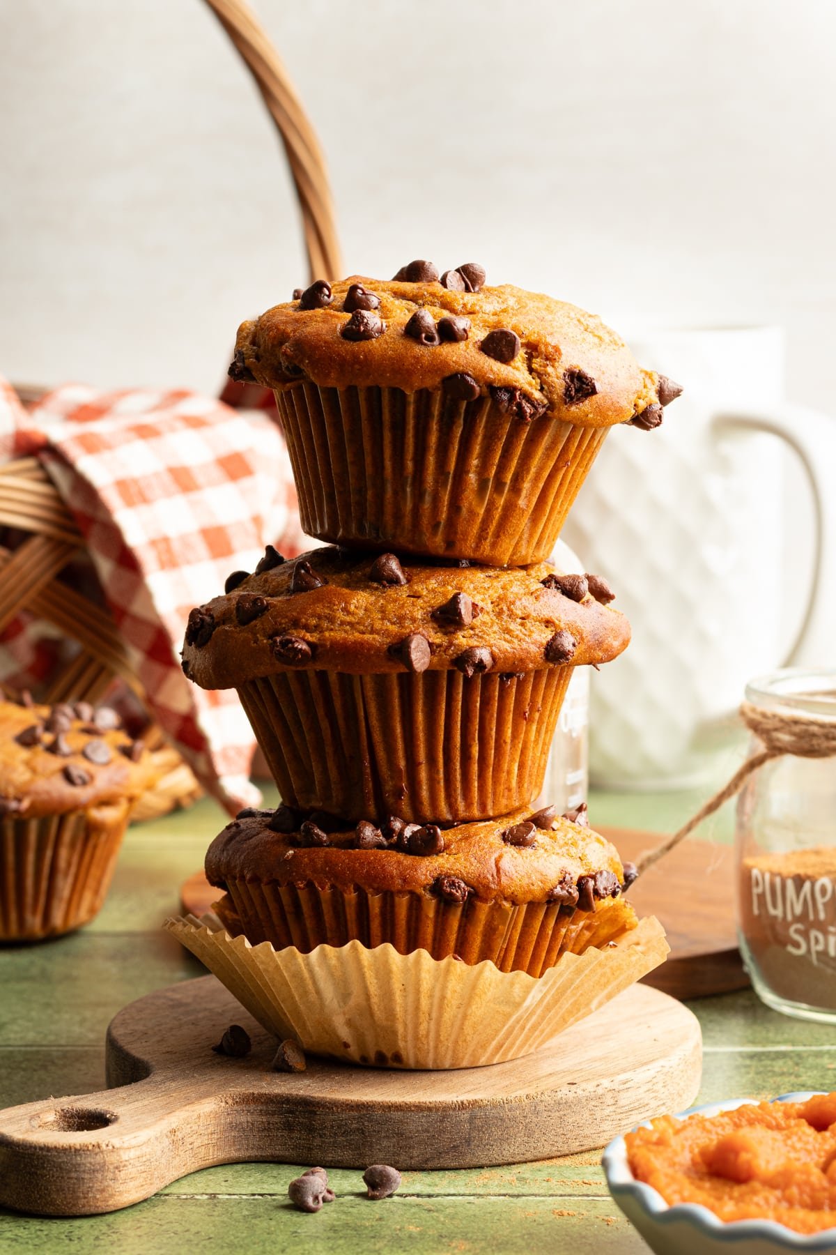 Cottage cheese pumpkin muffins stacked on top of one another.