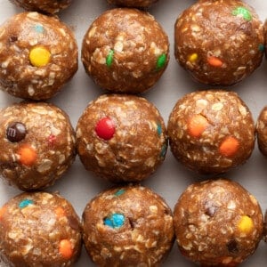 A close up shot of monster protein balls lined up on parchment paper.