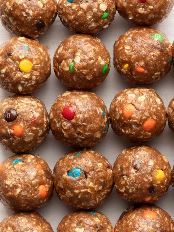 A close up shot of monster protein balls lined up on parchment paper.