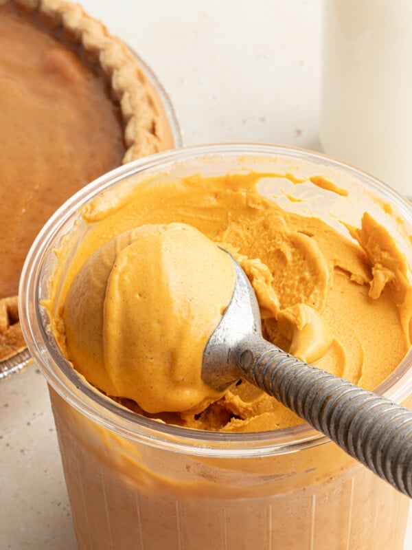 A ninja creami pint container with pumpkin ice cream.