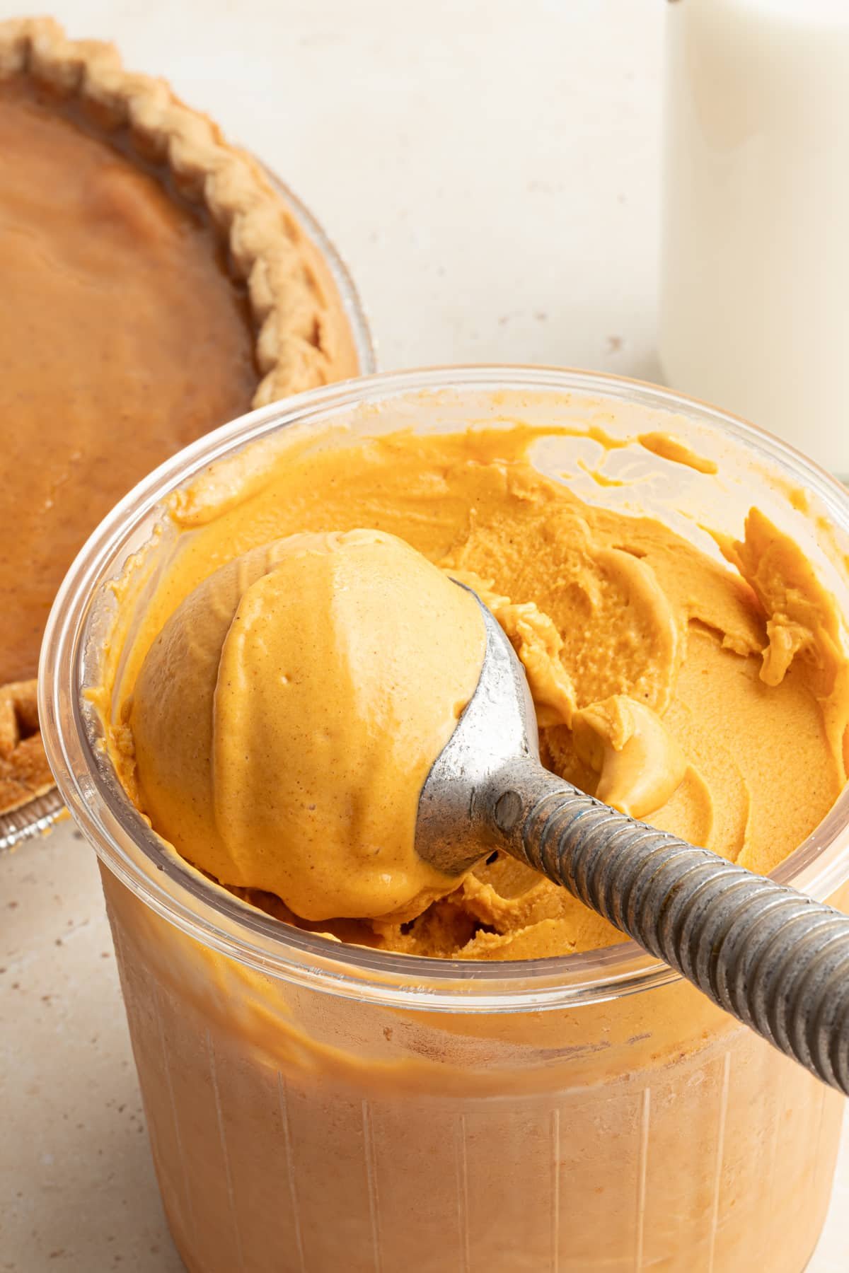 A ninja creami pint container with pumpkin ice cream.