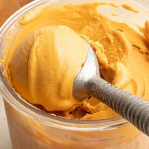 A ninja creami pint container with pumpkin ice cream.