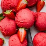 Scoops of ninja creami strawberry sorbet on a countertop.