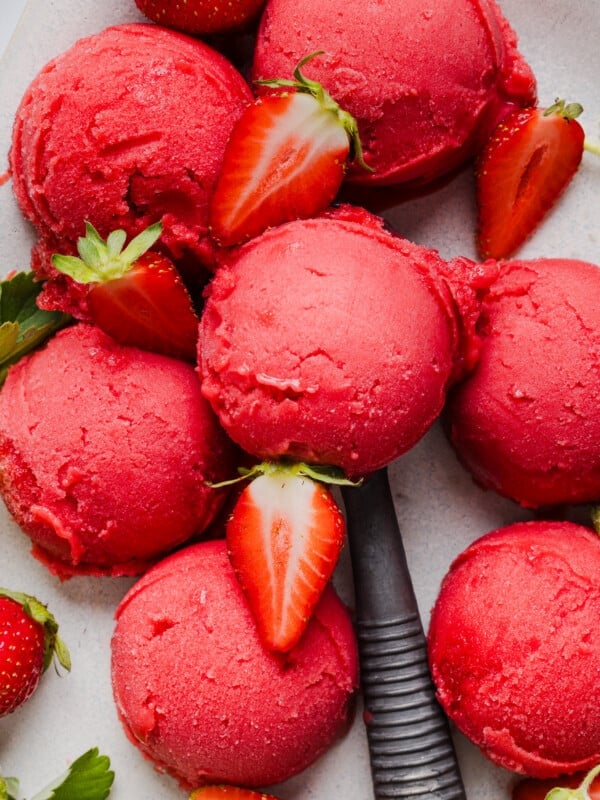 Scoops of ninja creami strawberry sorbet on a countertop.