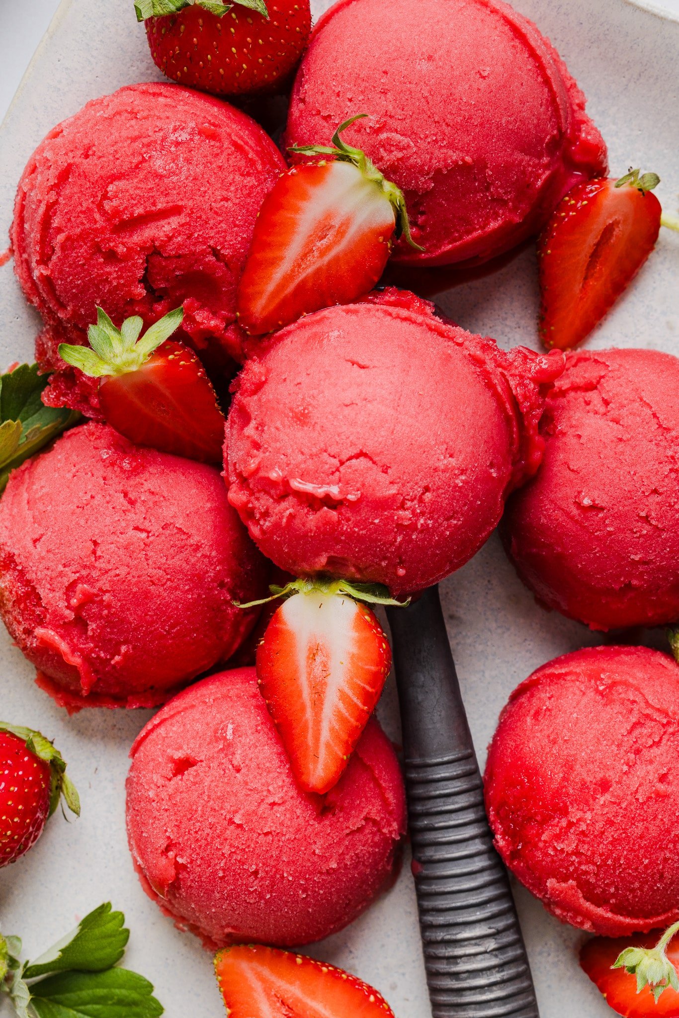 Scoops of ninja creami strawberry sorbet on a countertop.