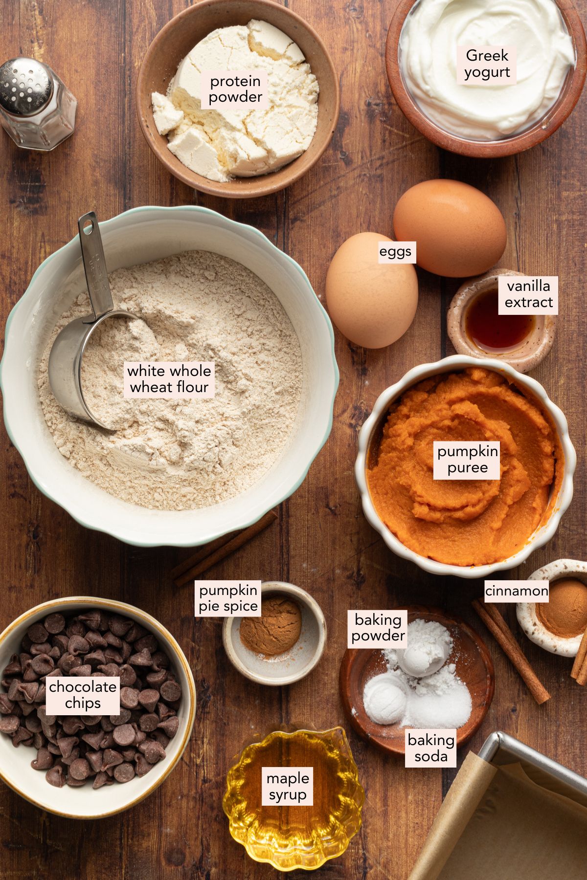 Ingredients for pumpkin protein bread on a countertop with labels.