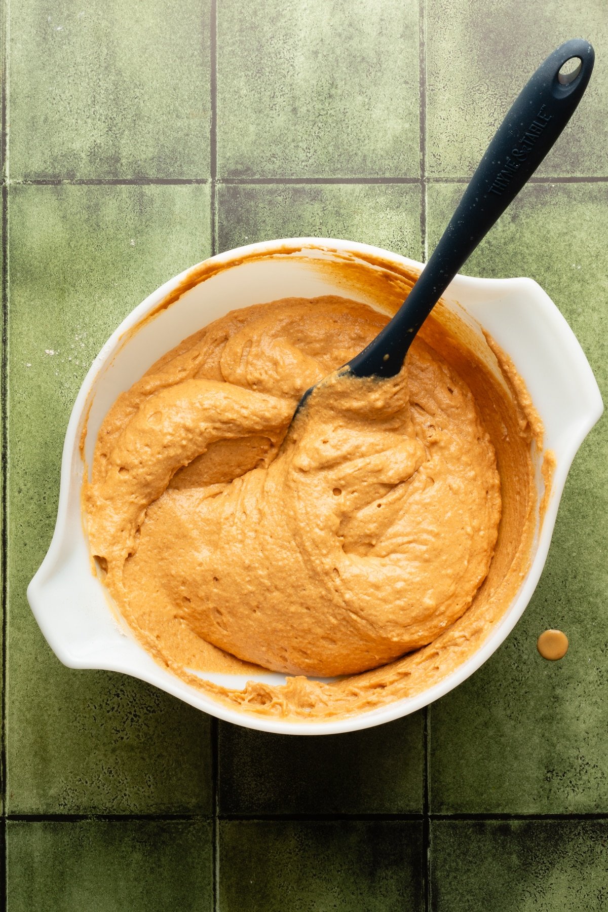 Pumpkin cottage cheese muffin batter in a large white bowl.