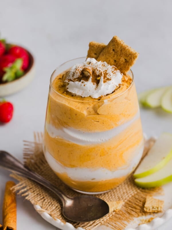 Pumpkin fluff layered with whipped cream in a glass.