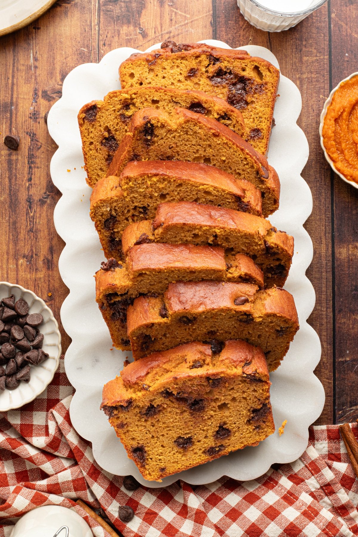 A loaf of pumpkin protein bread sliced on a platter.