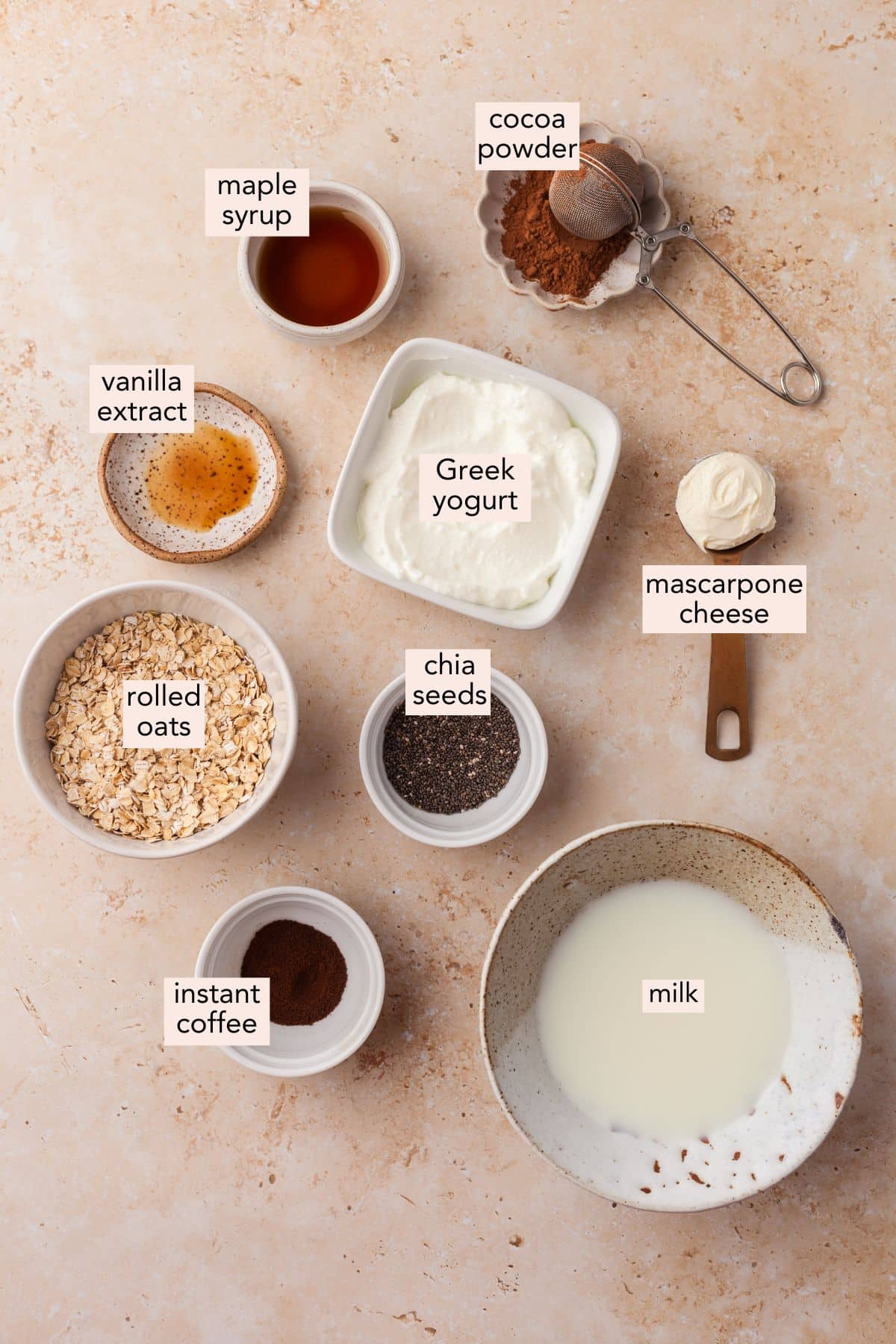 Ingredients for tiramisu overnight oats on a countertop with labels.