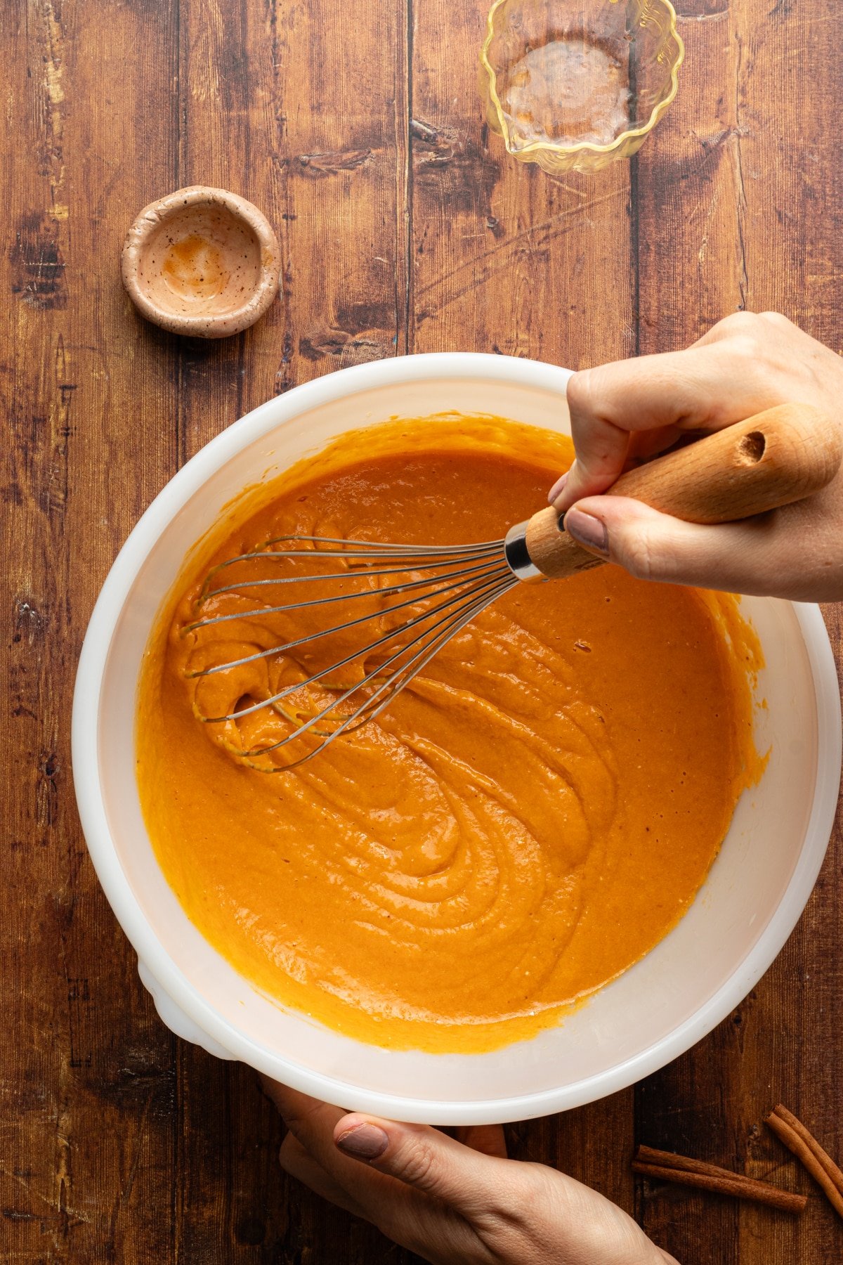 Wet ingredients for pumpkin protein bread being whisked together.