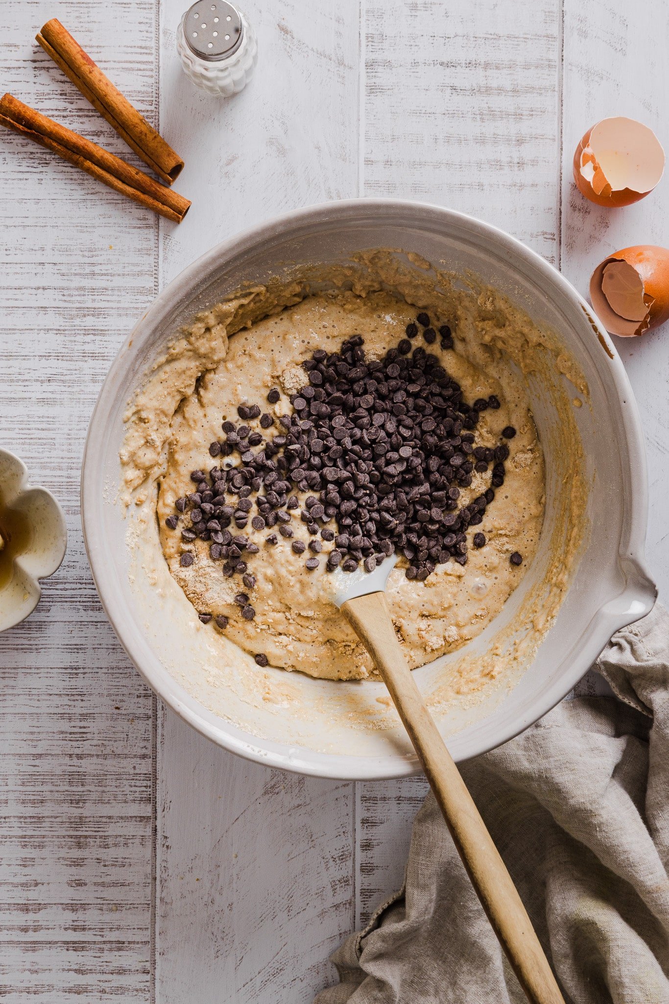 Chocolate chips being mixed into banana cottage cheese muffin batter.