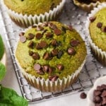 A spinach banana muffin on a cooling rack.
