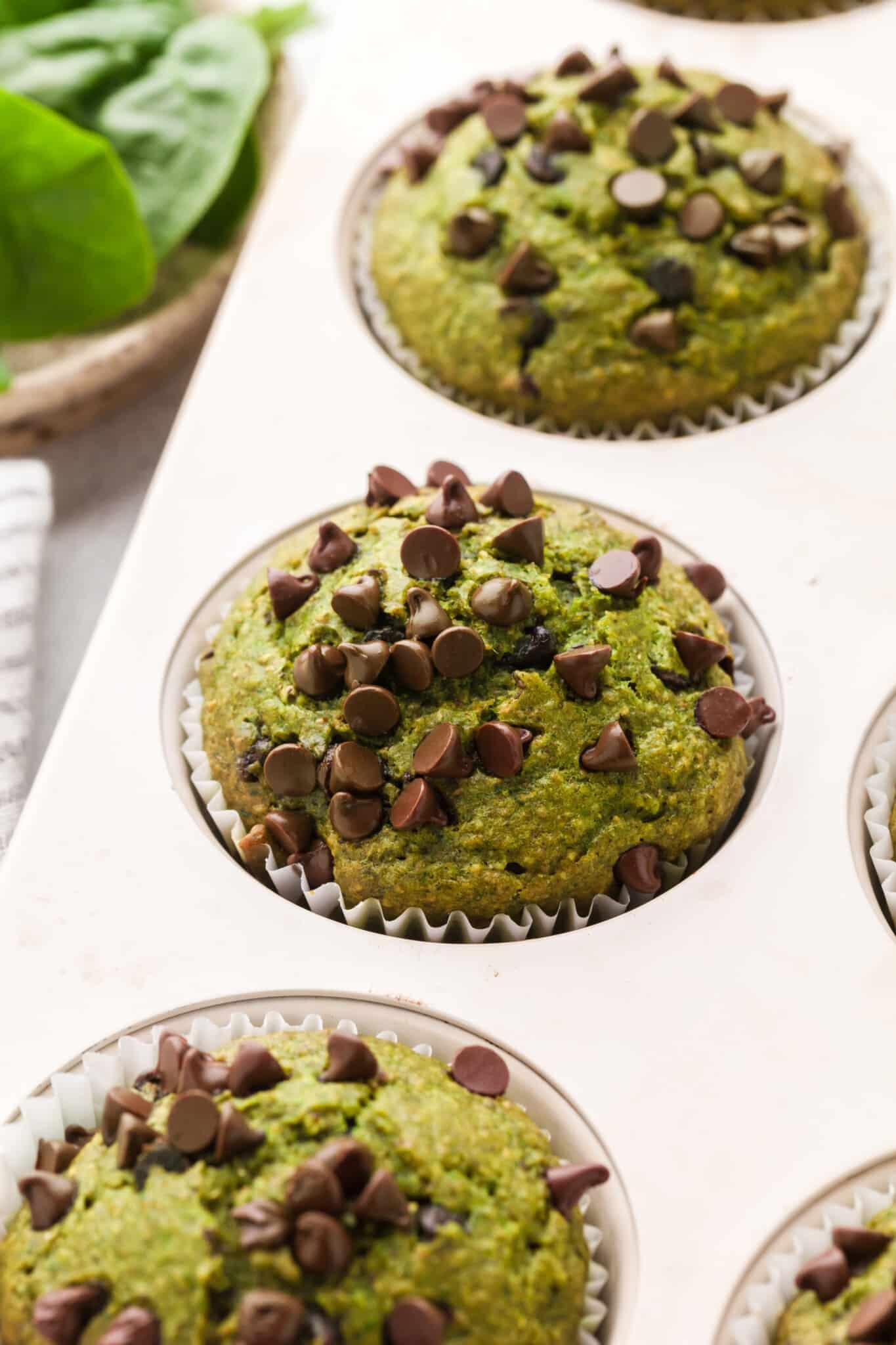 Spinach banana muffins baked in a muffin pan.