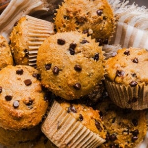 Cottage cheese banana muffins with mini chocolate chips in a pan with a stripped tea towel.