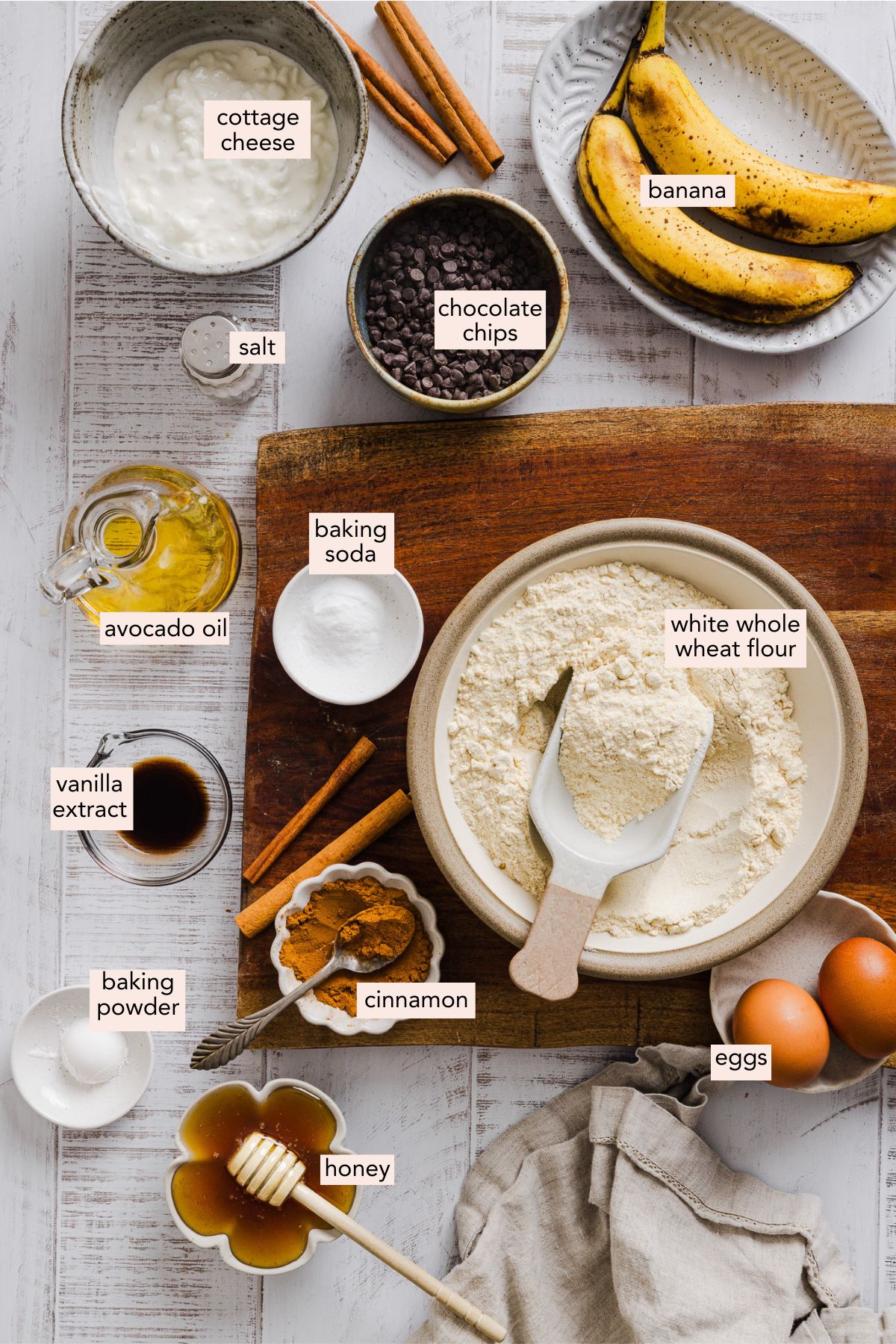 Banana cottage cheese muffin ingredients in small individual bowls on a counter top.