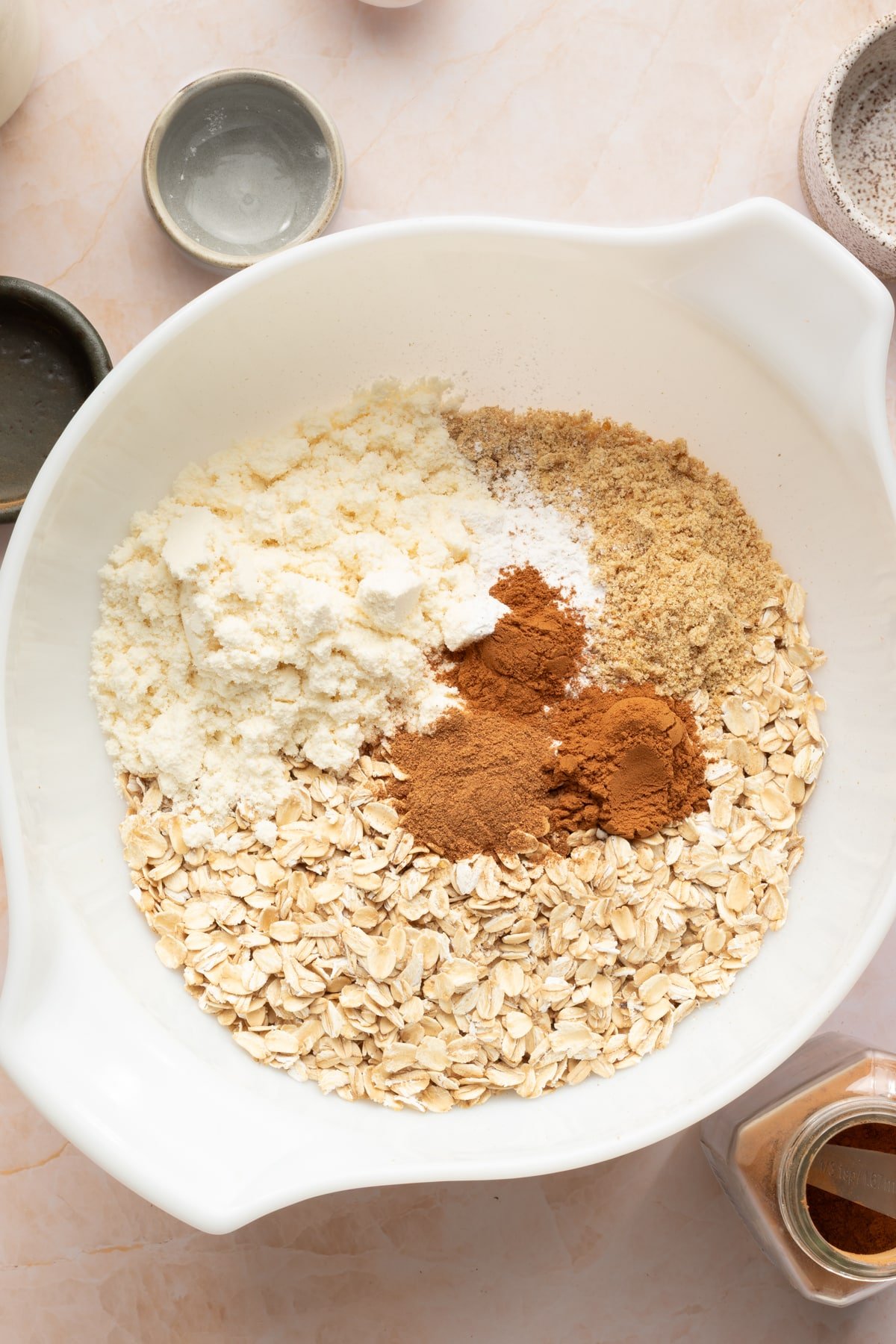 Dry ingredients for protein pumpkin baked oats in a white mixing bowl.
